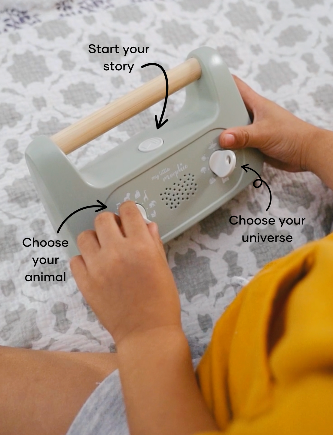 Sage green 'My Little Morphee' sleep aid device with a wooden handle, front view.