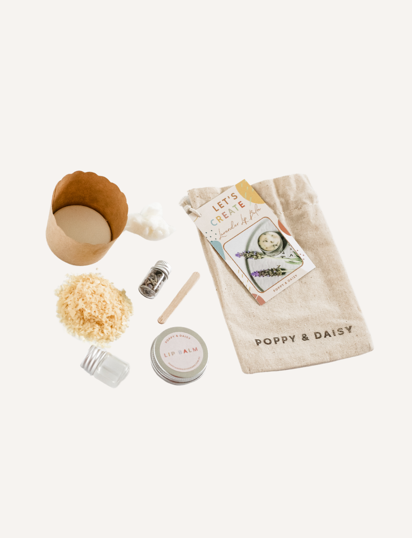 Poppy & Daisy Lavender Lip Balm DIY Kit: includes ingredients, tin, craft cup, and drawstring bag for making balm.