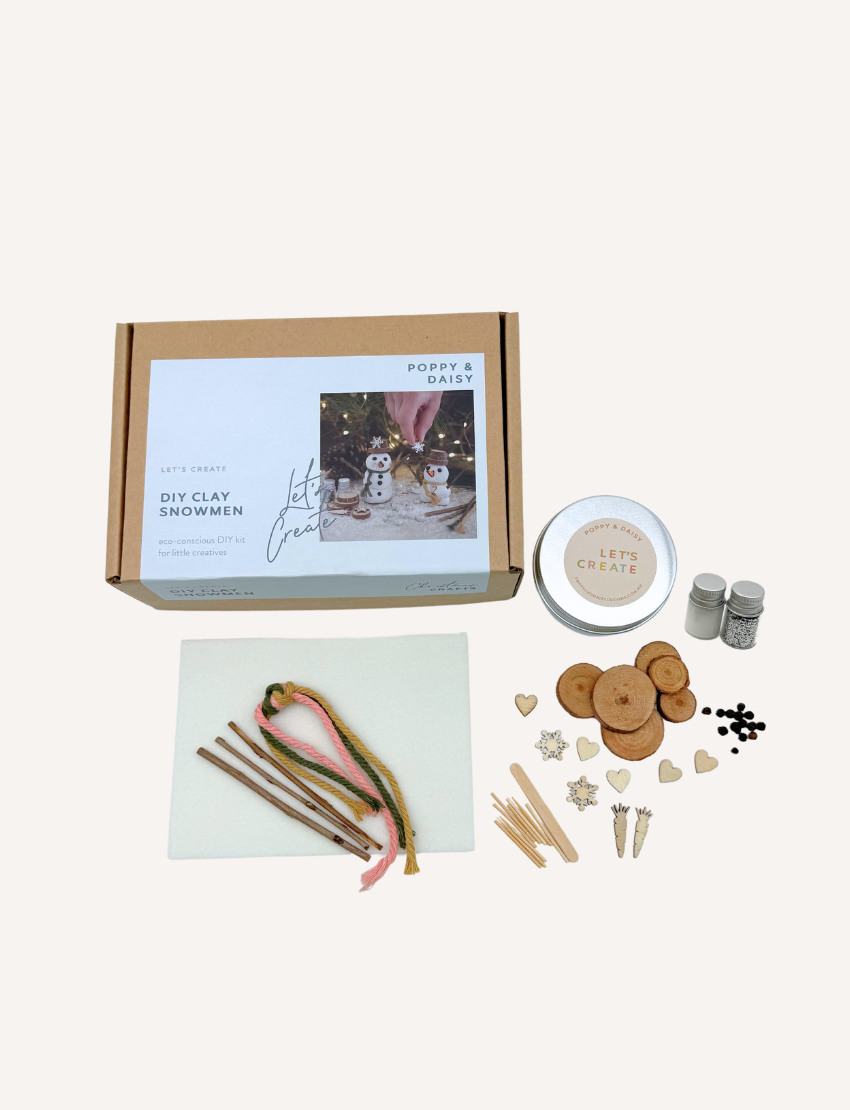 Poppy & Daisy DIY Clay Snowmen kit with box, clay, embellishments, and wooden pieces.