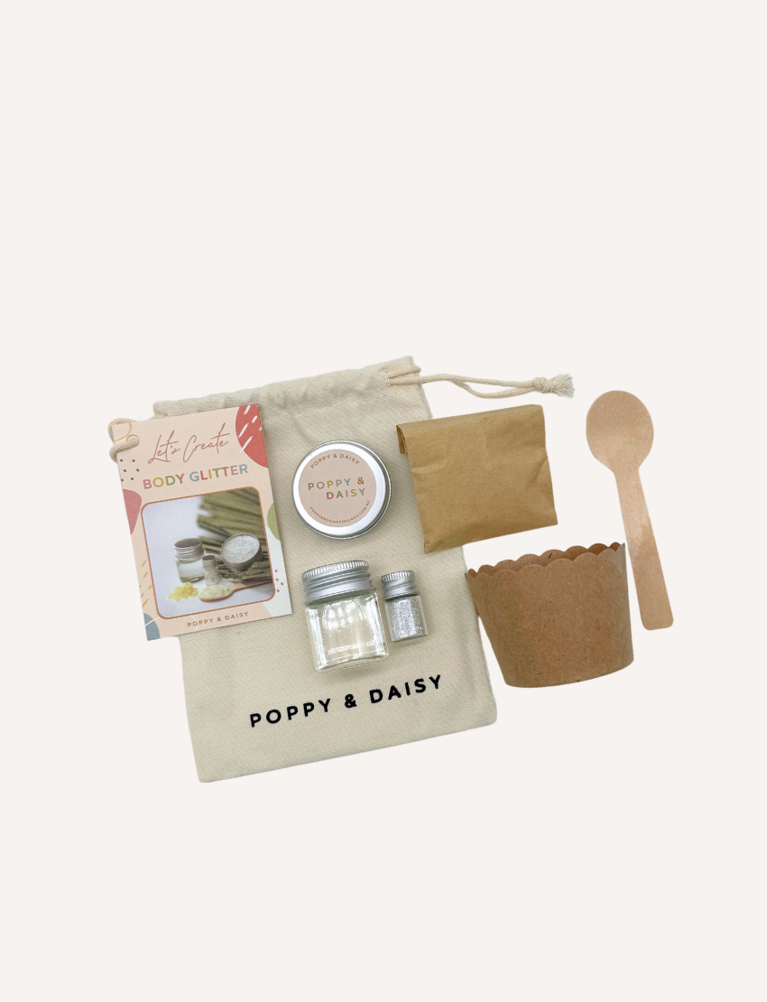 Poppy & Daisy 'Body Glitter' DIY kit: pouch, glitter bottles, tin, paper cup, wooden spoon, and instruction card.