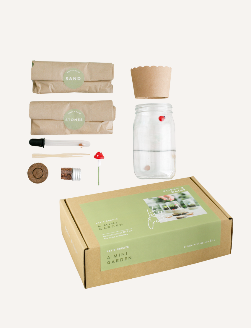 Poppy & Daisy 'A Mini Garden' DIY kit: box, jar, soil, seeds, stones, decorations, and tools.