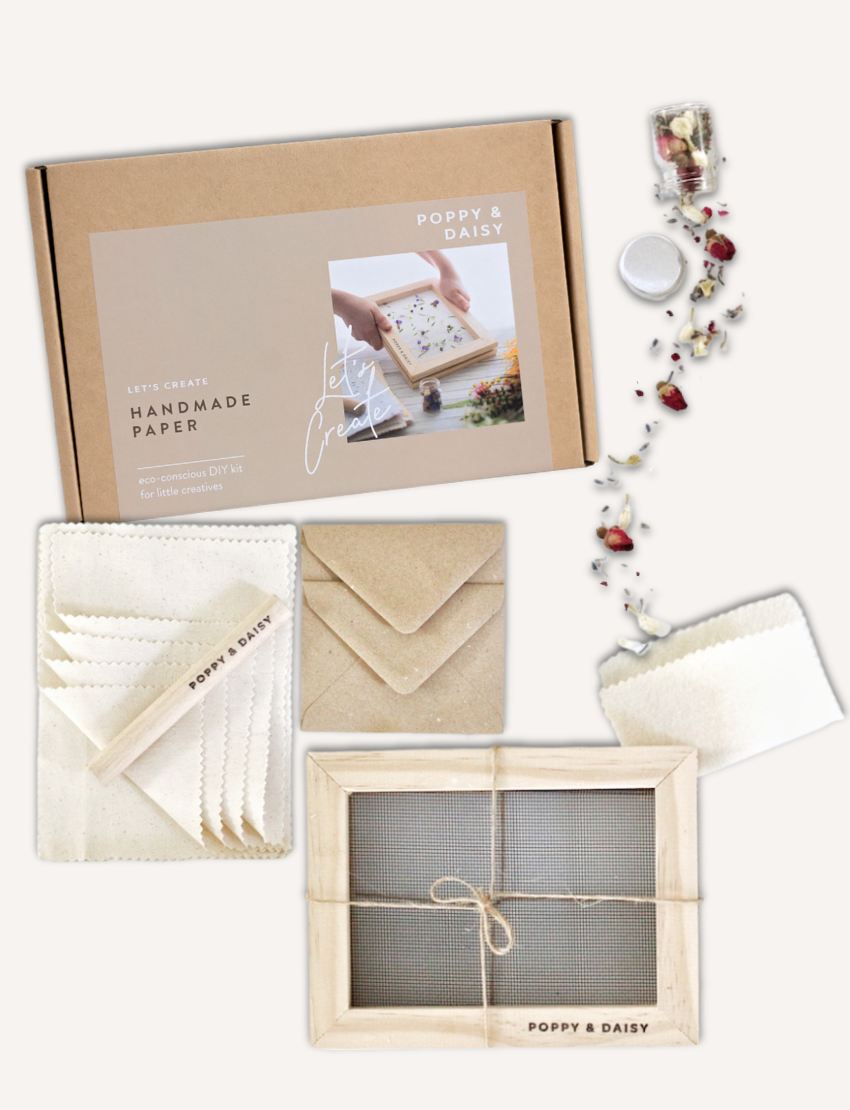 Poppy & Daisy handmade paper making kit with screen, paper pulp, envelopes, and dried flowers.