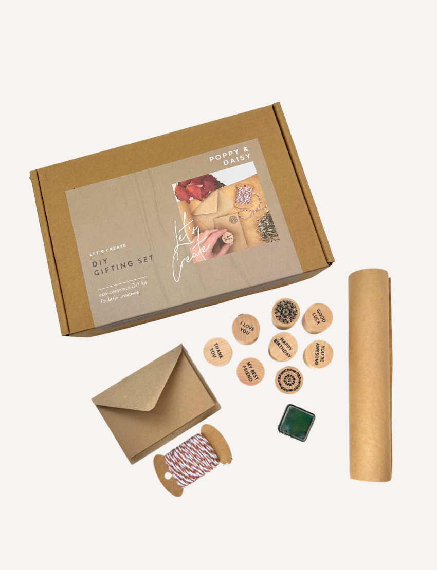 Poppy & Daisy DIY Gifting Set: Eco-conscious kit with stamps, twine, envelope, paper roll for creative gifting.