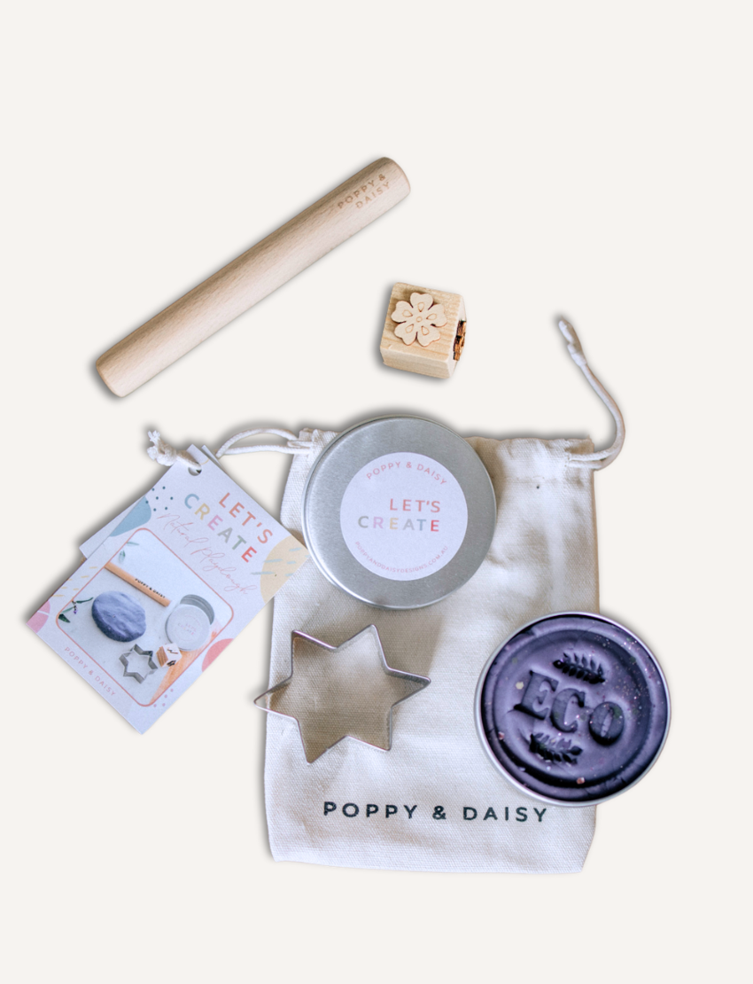 Poppy & Daisy natural playdough kit: purple playdough, star cutter, wooden stamp, roller, and bag.