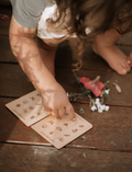 A person is holding a collection of nature-themed cards from Poppy & Daisy's 