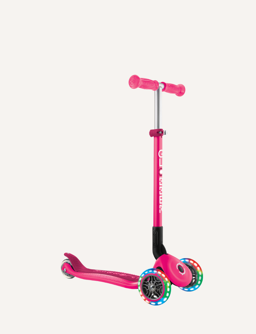 Pink PRIMO Foldable Lights Scooter, side view, with light-up wheels.