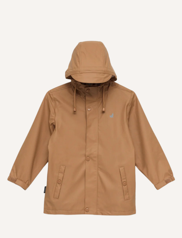 The Cry Wolf Play Jacket in tan is displayed against a white background. The raincoat features a front button closure, drawstrings on the hood, two front pockets with button flaps, and long sleeves with elastic cuffs. A small logo is visible on the left chest area.