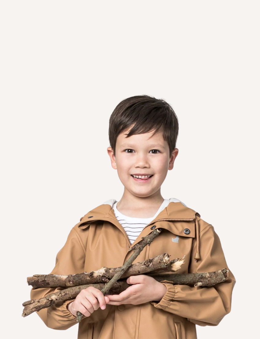 The Cry Wolf Play Jacket in tan is a waterproof hooded raincoat made from eco-friendly, recycled materials. It features a buttoned and zippered front, two flap-front pockets, elastic-cuffed long sleeves for comfort, and a small chest logo.