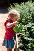 The EverEarth Outdoor Gardening Bag With Tools is a green set ideal for children's outdoor play, featuring a watering can, spade, trowel, and small fork with wooden handles. These tools are neatly displayed in front of a canvas tote decorated with green polka dots and multiple pockets.