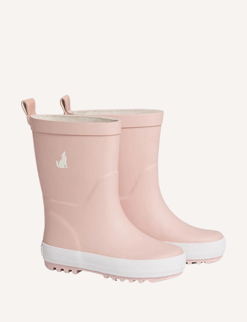 A pair of Cry Wolf's Rain Boots in Dusty Pink, featuring white soles and a small white silhouette of a dog logo on the side. The boots come with pull loops at the top and are showcased against a plain, light background.