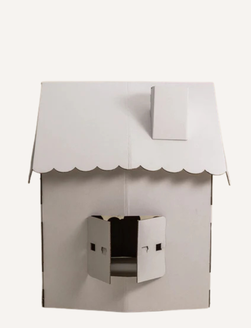 White cardboard playhouse with a scalloped roof and open window. Perfect for kids' imaginative and eco-friendly indoor play.