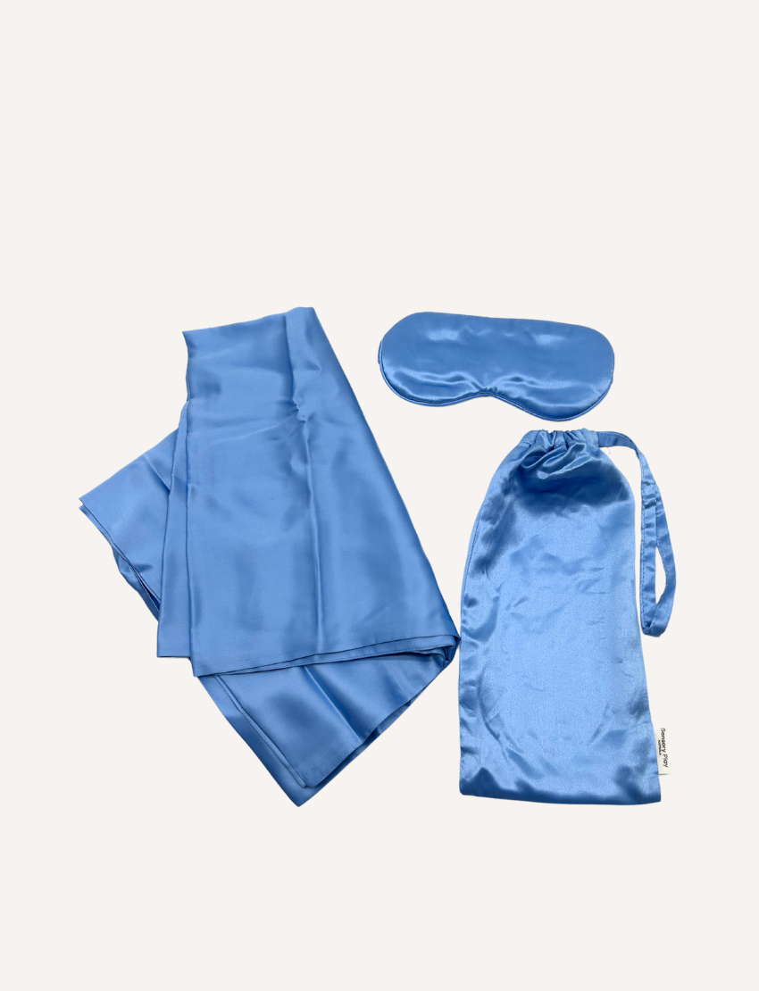 A folded silk pillowcase from Sensory Play Australia is shown next to a matching sleep mask. Both items from the Silk Pillowcase and Eye Mask Set are placed on a white background.