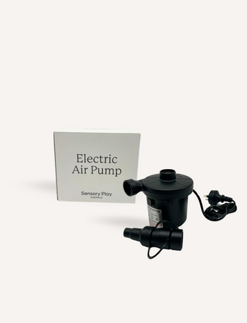 Next to its packaging box labeled "Electric Air Pump" from Sensory Play Australia is a black electric air pump, featuring an attached power cord and nozzle extension, set against a plain white background.