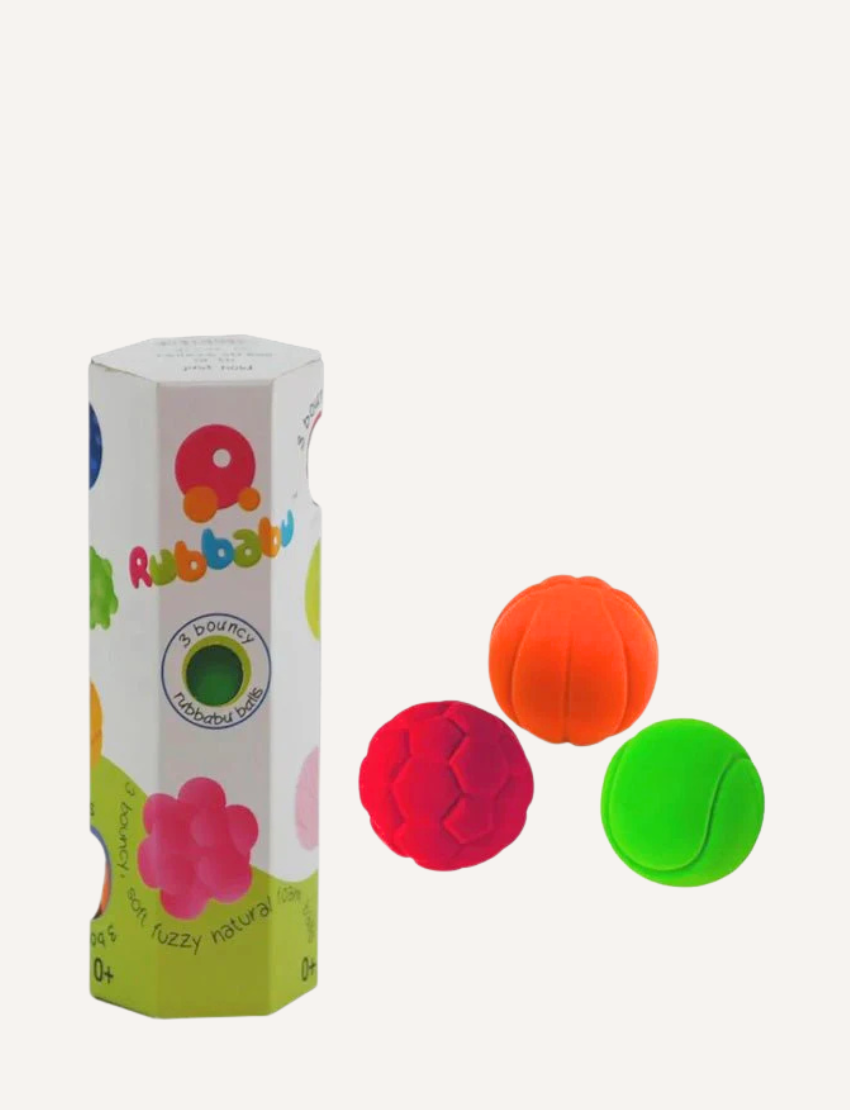 Image showcasing the Small Sports Balls Set of 3 by Rubbabu. The set includes three colorful foam balls in orange, red, and green, each featuring a unique texture. The packaging is a white box adorned with vibrant designs and branding.