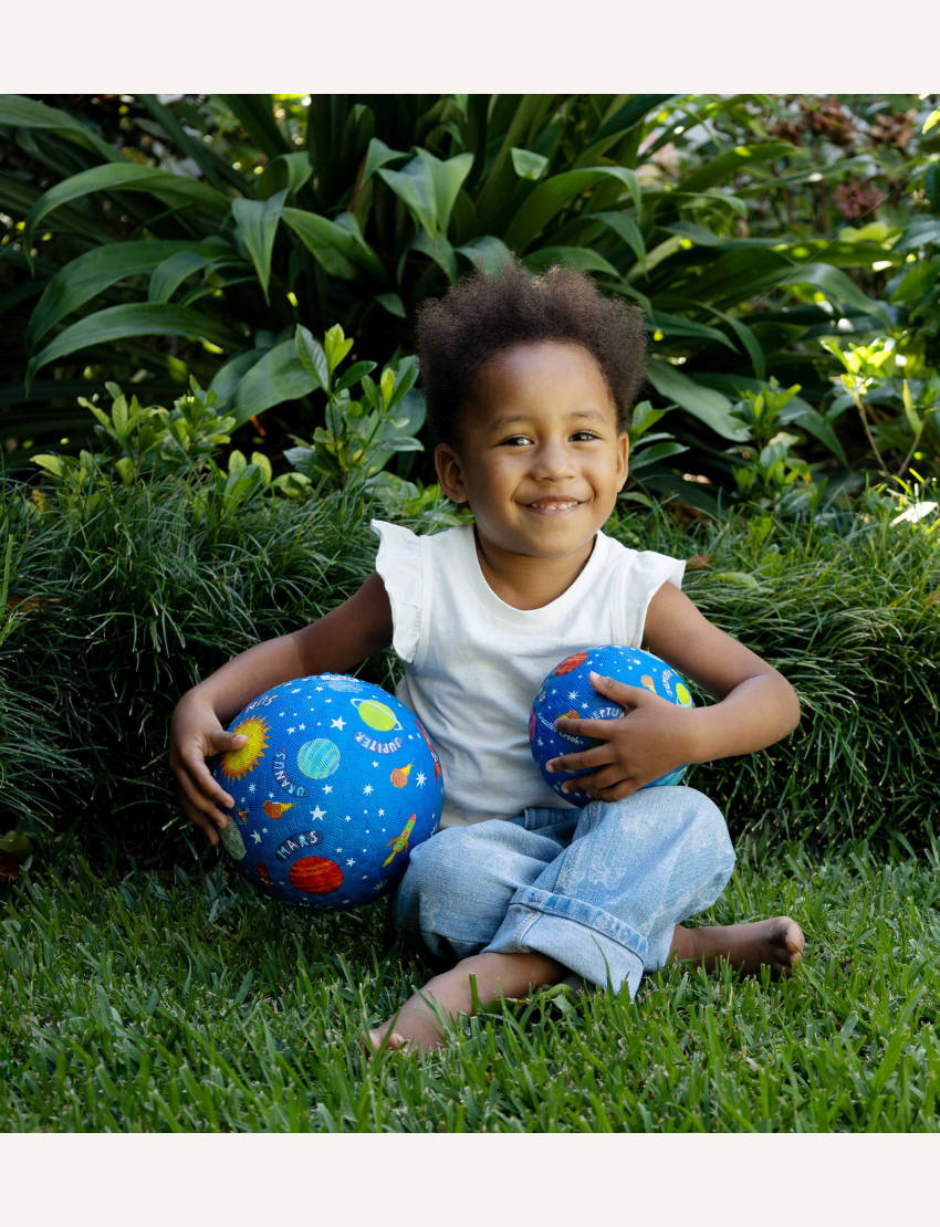 The Crocodile Creek 7 Inch Playground Ball - Shark Reef features a shark with small fish on a white background. Its blue rubber texture enhances grip, perfect for active play, and promotes gross motor skills in children.