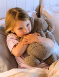 The Therapy At Home Sleep Program comes in a teal and green abstract box filled with a plush koala, children’s sleep books, white eye mask, mini fan, lotion, journal, markers, and cards.