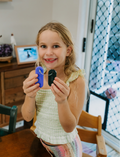 The Regulation: Attention and Learning Program by Therapy At Home is an open teal box packed with sensory and educational tools, including 