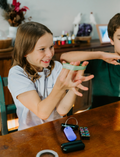 The Regulation: Attention and Learning Program by Therapy At Home is an open teal box packed with sensory and educational tools, including 