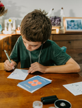 The Regulation: Attention and Learning Program by Therapy At Home is an open teal box packed with sensory and educational tools, including 
