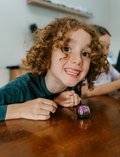 The Regulation: Attention and Learning Program by Therapy At Home is an open teal box packed with sensory and educational tools, including 
