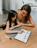 The Therapy At Home Self-Care Program features an open teal gift box filled with lotions, a striped bag, skincare essentials, cards, a hairbrush, and more—perfectly arranged for your self-care routine.