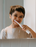The Therapy At Home Self-Care Program features an open teal gift box filled with lotions, a striped bag, skincare essentials, cards, a hairbrush, and more—perfectly arranged for your self-care routine.