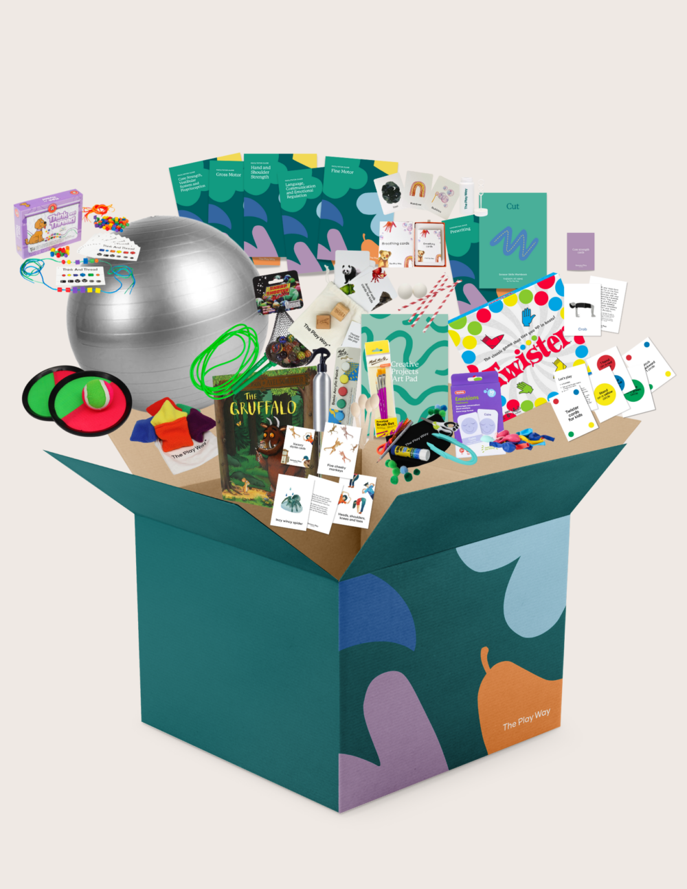 The Therapy At Home Ready for School Program features a large green and blue box filled with a silver exercise ball, books, cards, activity kits, and sensory toys—selected by occupational therapists—arranged on a light background.