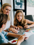 An open blue and green box from Therapy At Home's Build it with Bricks Foundation Program includes two LEGO Classic sets and colorful activity cards—ideal for supporting executive function skills in therapy sessions—displayed on a plain light background.