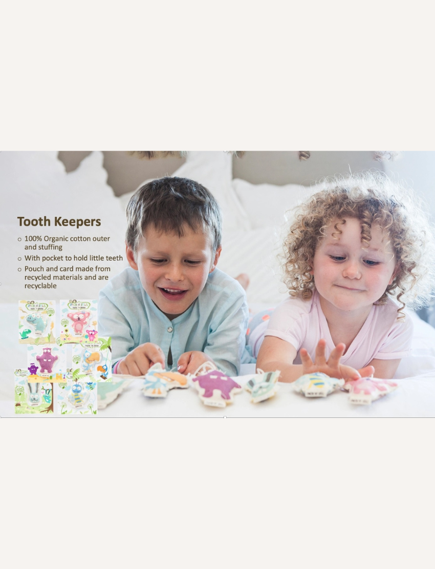 A boy and a girl are lying on a bed, enjoying their play with small plush toys from Jack N' Jill's "Tooth Keeper" collection. The image highlights the features of these toys, including their organic cotton material and recyclability, with an assortment of different designs showcased on the left.